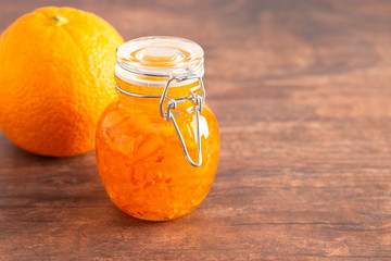 Jar of Homemade Orange Marmalade on a Rustic Wooden Table
