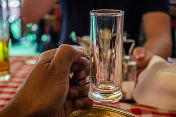 Man holding hungarian palinka alcohol shot glass during the gathering of friends