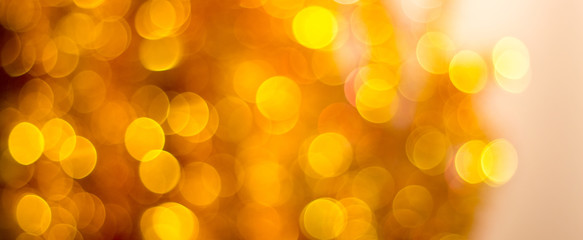Obraz premium Abstract blurred background with bokeh in golden colors_
