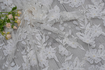 The texture of lace on wooden background decoreted roses.
