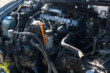 Fototapeta na wymiar full size old diesel engine on a disassembled car