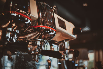 New shiny coffee machine at coffee shop is ready to start making coffee. Closeup photo shoot.