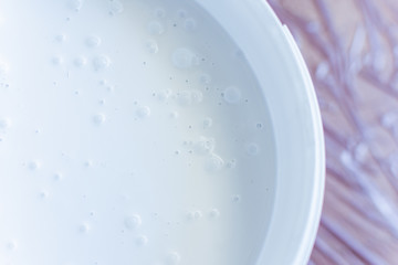 Can of white paint on the floor ,the floor is covered with a oilcloth for protection