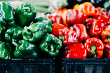 Red and green bell peppers at farmers market