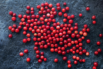 Raw organic fresh cowberry or lingonberry on dark stone table