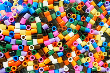 Assorted colors of Ikea Pyssla thermo mosaic beads, selective focus