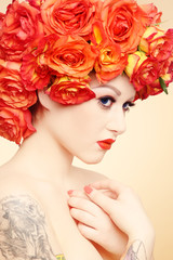Naklejka premium Vintage style portrait of young beautiful woman with fancy makeup and wig of orange roses