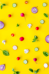Layout of colorful vegetables on yellow background top view pattern