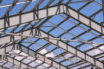Steel structure of building construction on blue sky background