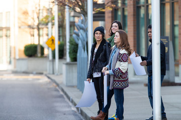 Diverse group of people outside crossing the street