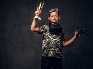 Little proud champion just won the competition in virtual reality games and got the cup.