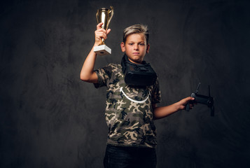 Little proud champion just won the competition in virtual reality games and got the cup.