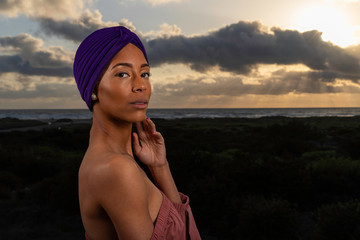 Portrait of beautiful African American woman at sunset wearing turban