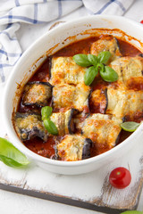 Baked eggplant rolls with meat (minced pork, beef, veal, lamb) in tomato sauce with herbs. Delicious summer food, traditional