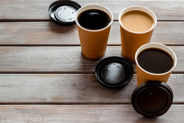 paper cups with black coffee and cappuccino to take away on wooden background mock-up