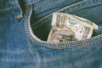 Last crumbled  one hundred US Dollar bill in jeans pocket as symbol of poverty and bankruptcy. Not...