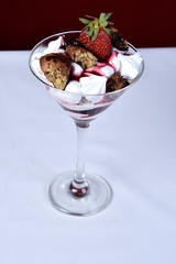 dessert in bowl with fruits on black background.