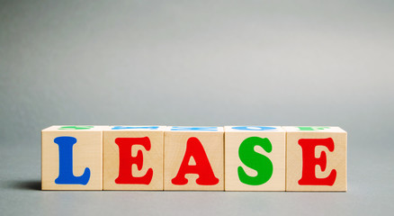 Wooden blocks with the word Lease. Rental with repurchase rights. Financial service. Acquisition of...