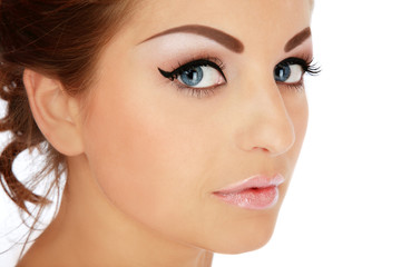 Vintage style portrait of beautiful blue-eyed girl with fancy winged eye makeup