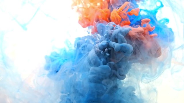 red and blue Ink in water mixed close up. white background