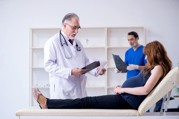 Fototapeta premium Two doctors examining young woman