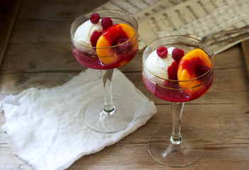 Ice cream, peach and raspberry sauce dessert dedicated to Australian opera singer Melba. Rustic style.