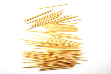 Toothpicks isolated on white background. Tooth picks spilling out of container.