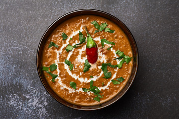 Dal Makhani at dark background. Dal Makhani - traditional indian cuisine puree dish with urad beans, red beans, butter, spices and cream. - obrazy, fototapety, plakaty
