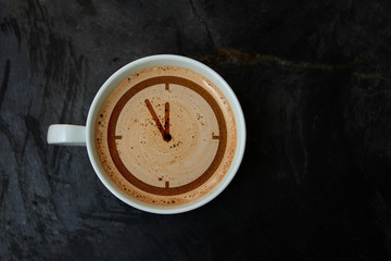 white cup with cappuccino and foam in the form of a pattern watch dial, top view, close-up, copy space