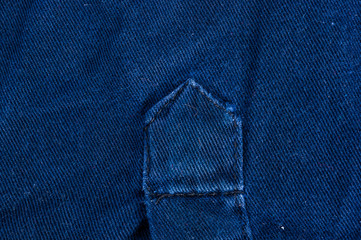 clothing items stonewashed cotton fabric texture with seams, clasps, buttons and rivets, macro