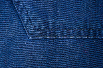 clothing items stonewashed cotton fabric texture with seams, clasps, buttons and rivets, macro
