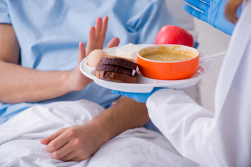 Male patient eating food in the hospital