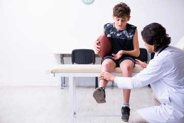 Boy american football player visiting young doctor traumatologis