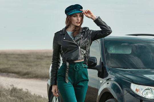 High Fashion Portrait Of Brunette Woman Outside In Leather Black Jacket And Trendy Hat. Outdoor Fashion.