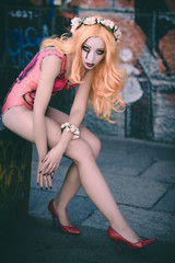 Naklejka premium Bloody halloween. Dead bride with blood eyes and scary costume in red high heels. Mysterious model girl with halloween make up