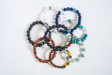 High angle view on crystal semiprecious stone beads bracelets gems natural stones for manifesting and healing energy handmade for good fortune on the table