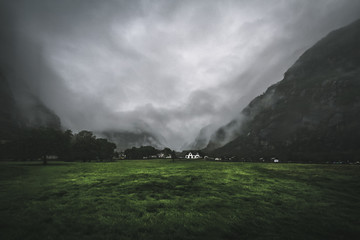 Lonely house standing in a misty mountains