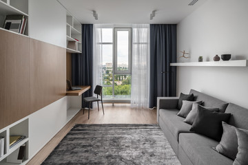 Stylish modern interior with white walls and parquet with carpet