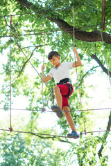 young boy, teenager, in a rope park, engage in extreme games, child development, boy hobbies