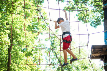 young boy, teenager, in a rope park, engage in extreme games, child development, boy hobbies