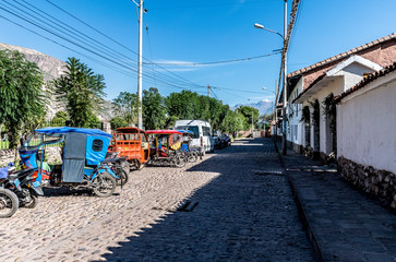 Sacred Valley, Peru - 05/21/2019: Street filled with vehicles in Yucay, Peru.
