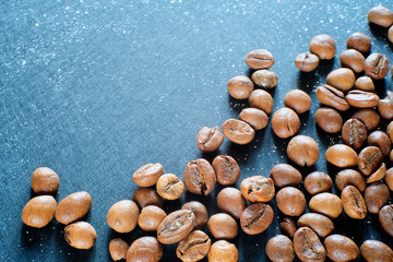 Coffee, Golden beans brown on blue background. Concept for a culinary magazine. Beautiful morning coffee