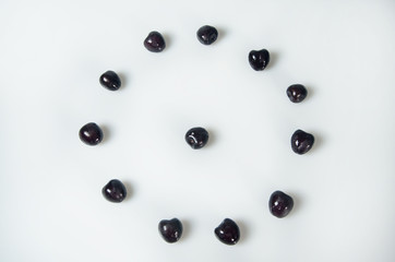 Composition on white background with cherry