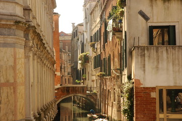 Fototapeta premium Venice canal with boats and vintage walls