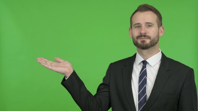 Businessman Holding Something without theme against Chroma Key