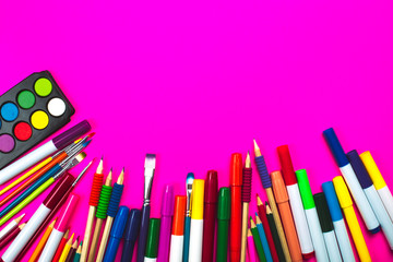School supplies on pink neon background and note book with copy space. Back to school concept.
