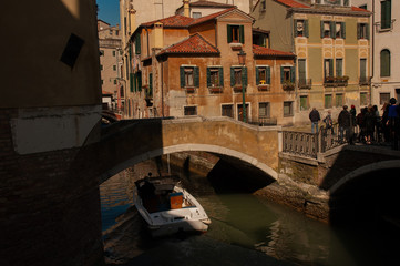 Obraz na płótnie Canvas Venice canal with boats and vintage walls