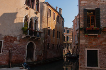 Fototapeta na wymiar Venice canal with boats and vintage walls