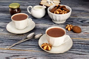 Fototapeta na wymiar Cups with cocoa on a wooden table