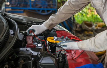 Fototapeta premium Auto repair service technician checking car battery